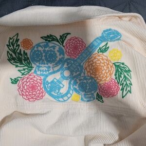 Disney Cream Top with Colorful Floral and Guitar Design